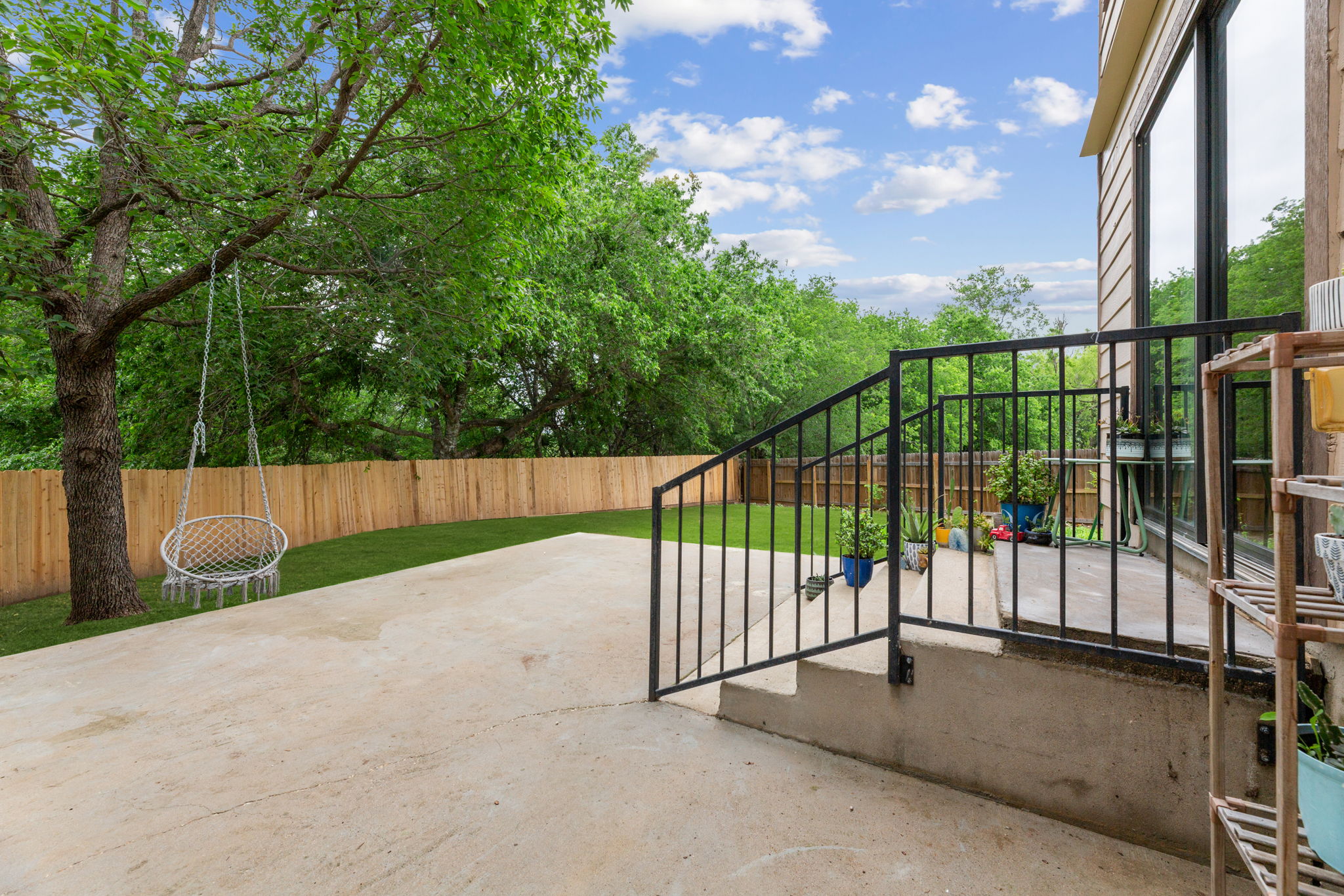 310 Myrtle Street Kyle, TX 78640 - Photo 26 of 39 Expansive concrete patio ready for dining outdoors.(green grass photography edit)