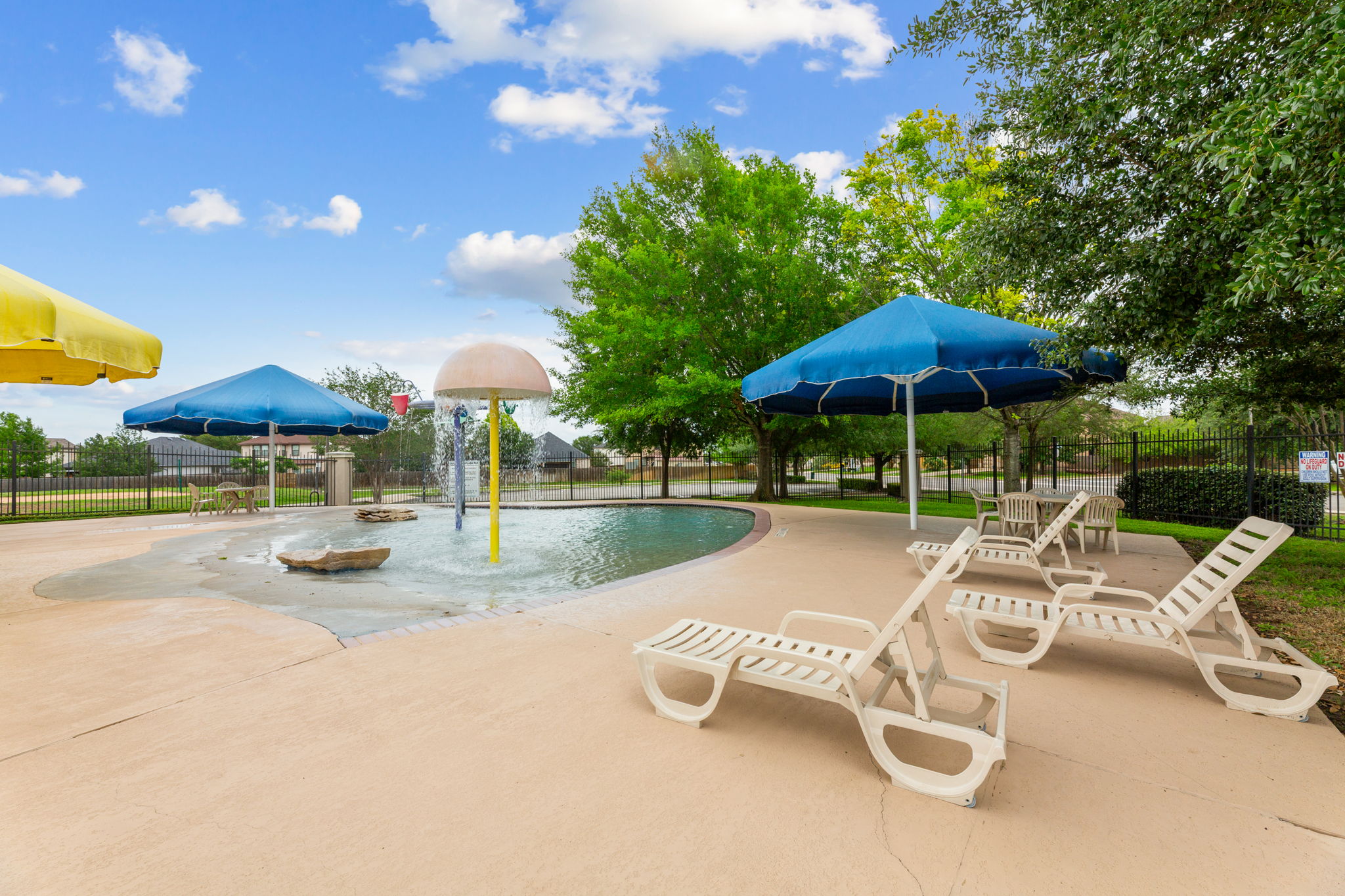 310 Myrtle Street Kyle, TX 78640 - Photo 32 of 39 a view of a patio with a table and chairs under an umbrella