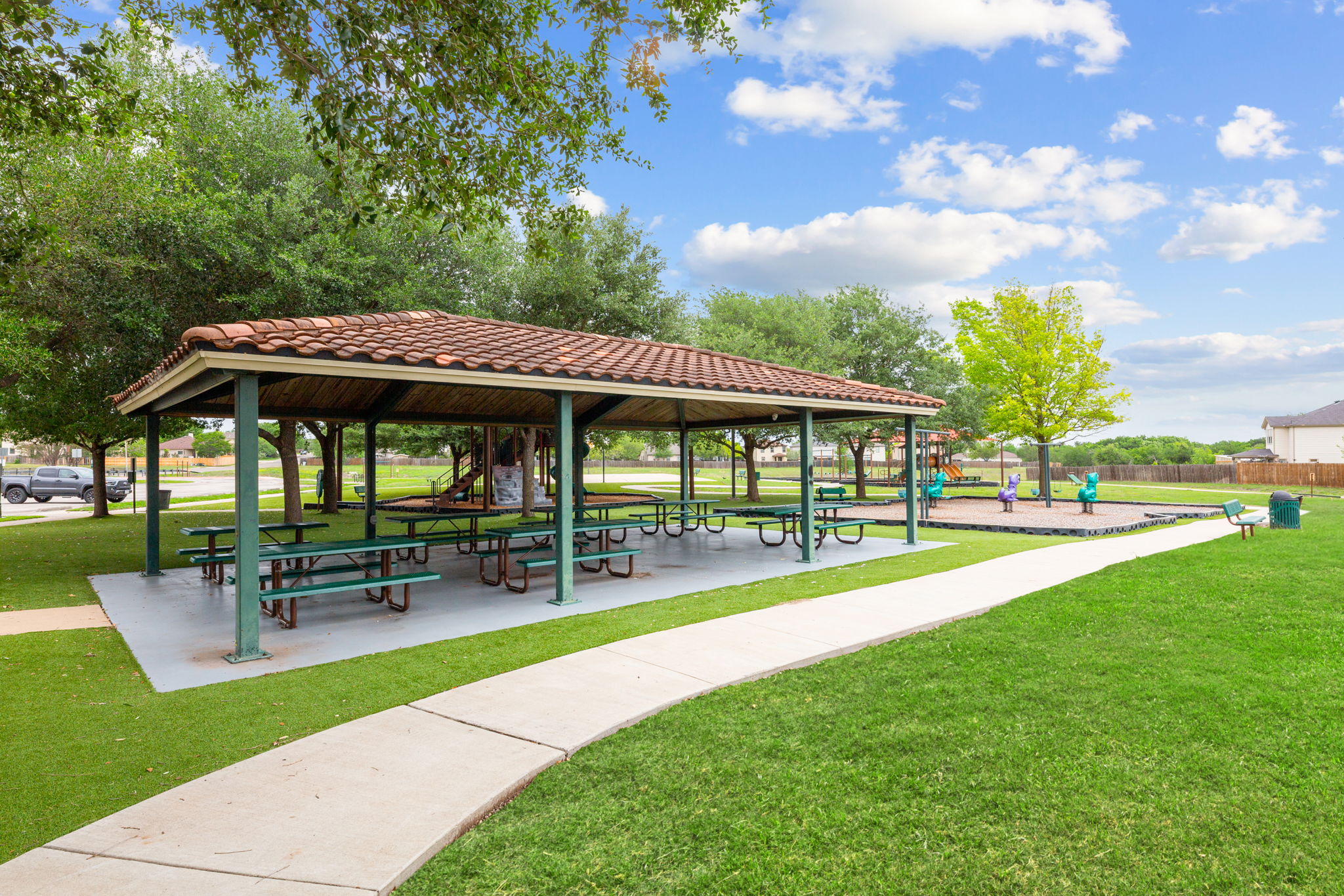 310 Myrtle Street Kyle, TX 78640 - Photo 35 of 39 a view of a patio with a table and chairs under an umbrella