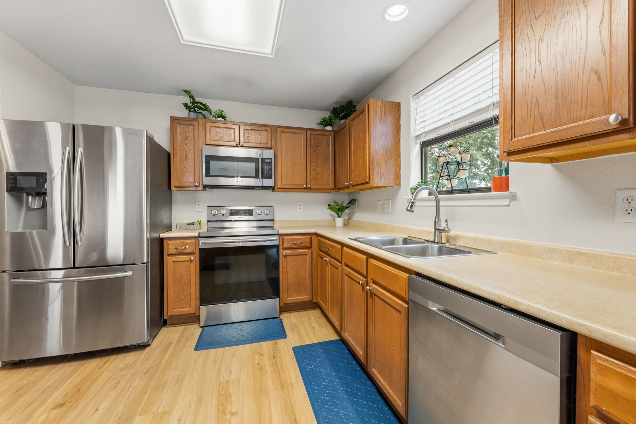 310 Myrtle Street Kyle, TX 78640 - Photo 7 of 39 a kitchen with granite countertop stainless steel appliances a sink cabinets and a window
