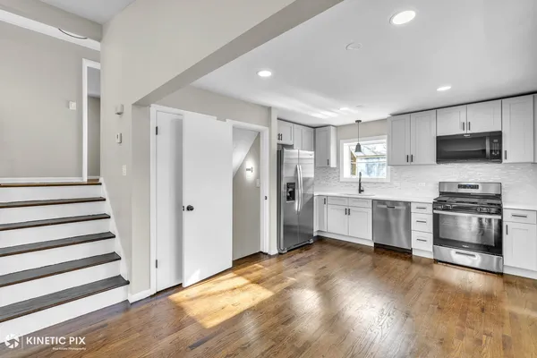 a kitchen with stainless steel appliances a refrigerator sink and microwave