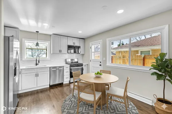 a kitchen with white cabinets stove and refrigerator