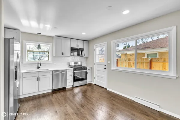 a kitchen with stainless steel appliances granite countertop a stove a sink and a refrigerator