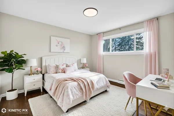 a bedroom with a bed and a potted plant