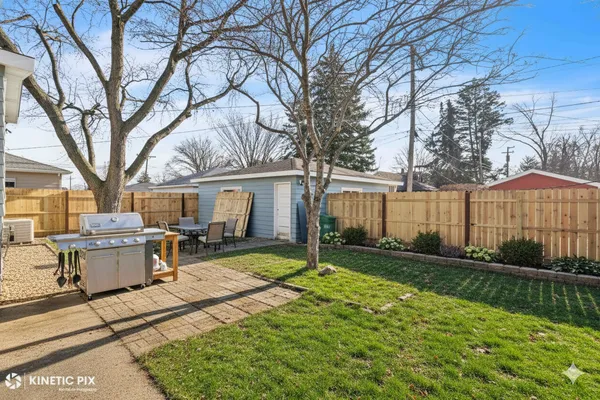 a view of a house with backyard and sitting area