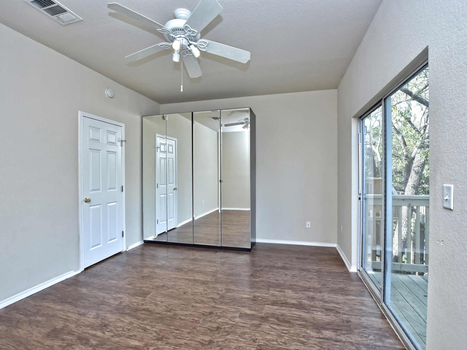 917 East 3rd Street Georgetown, TX 78626 - Photo 10 of 23 Ample floor space and a private balcony enhance this bedroom's liveability.