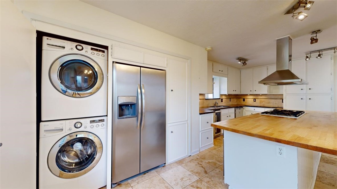 3004 Gleneagles Court Bryan, TX 77802 - Photo 11 of 38 a view of a storage and utility room with washer and dryer