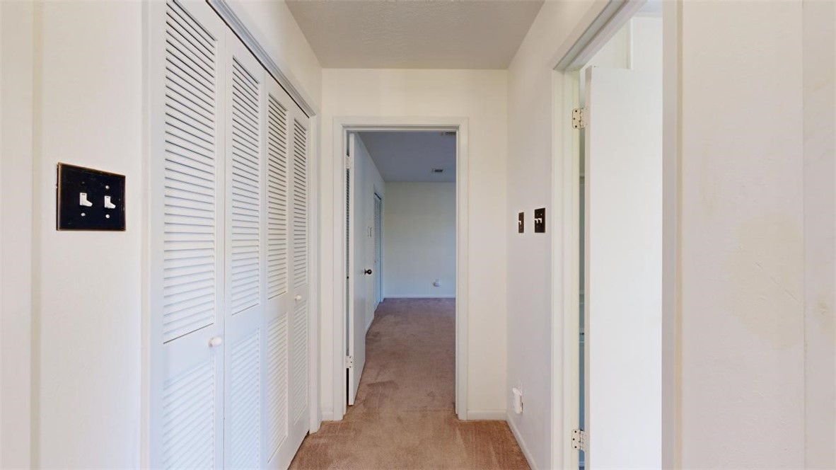 3004 Gleneagles Court Bryan, TX 77802 - Photo 21 of 38 a view of a hallway with wooden shelves