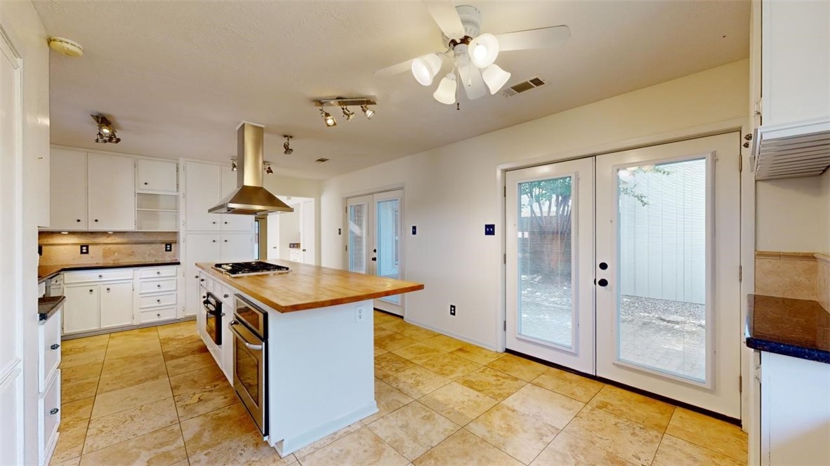 3004 Gleneagles Court Bryan, TX 77802 - Photo 9 of 38 a kitchen with stainless steel appliances granite countertop a stove and a refrigerator