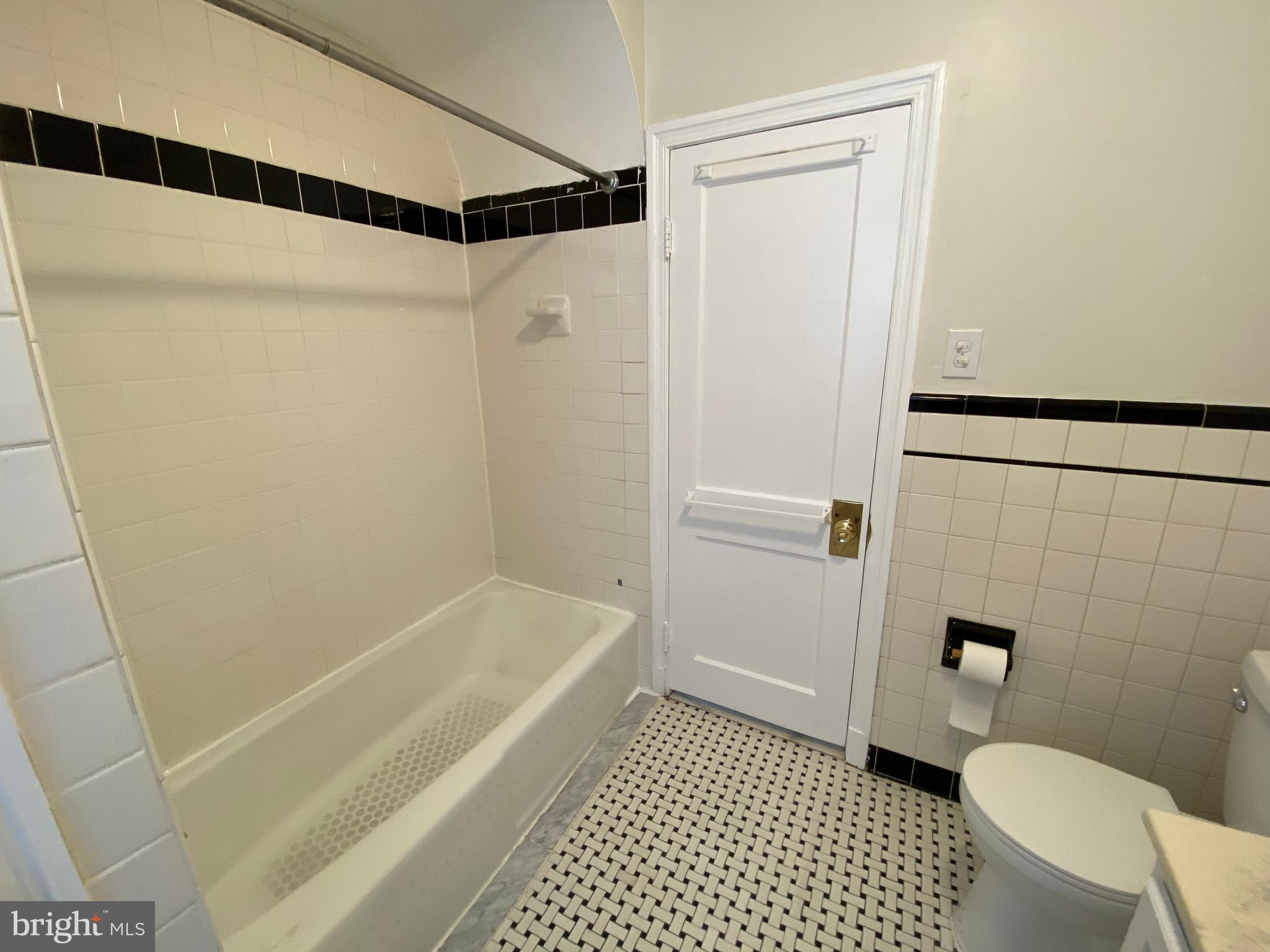 9532 Belair Road Baltimore, MD 21236 - Photo 18 of 20 a bathroom with a shower and a toilet