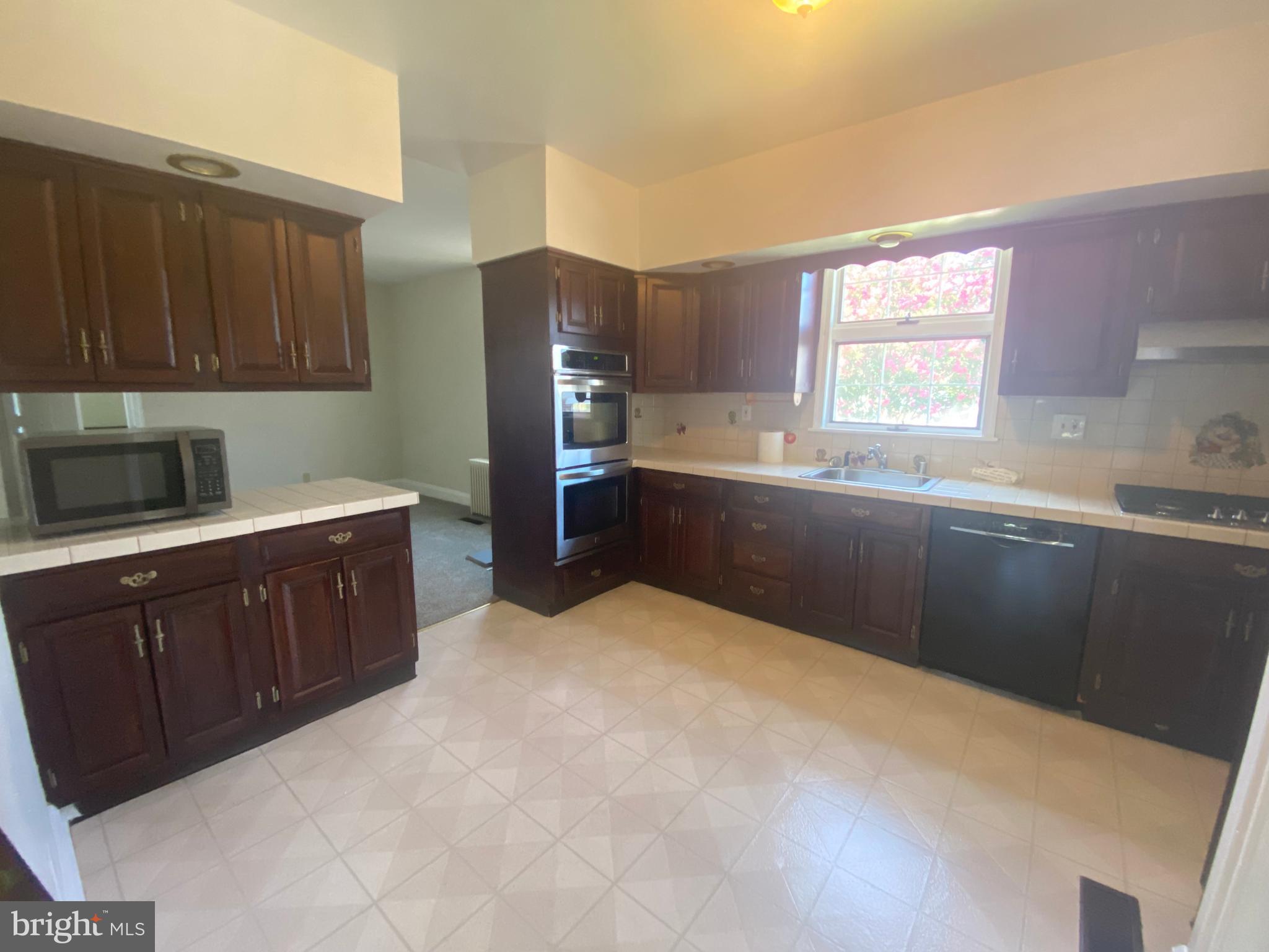 9532 Belair Road Baltimore, MD 21236 - Photo 5 of 20 a kitchen with stainless steel appliances a refrigerator sink and cabinets