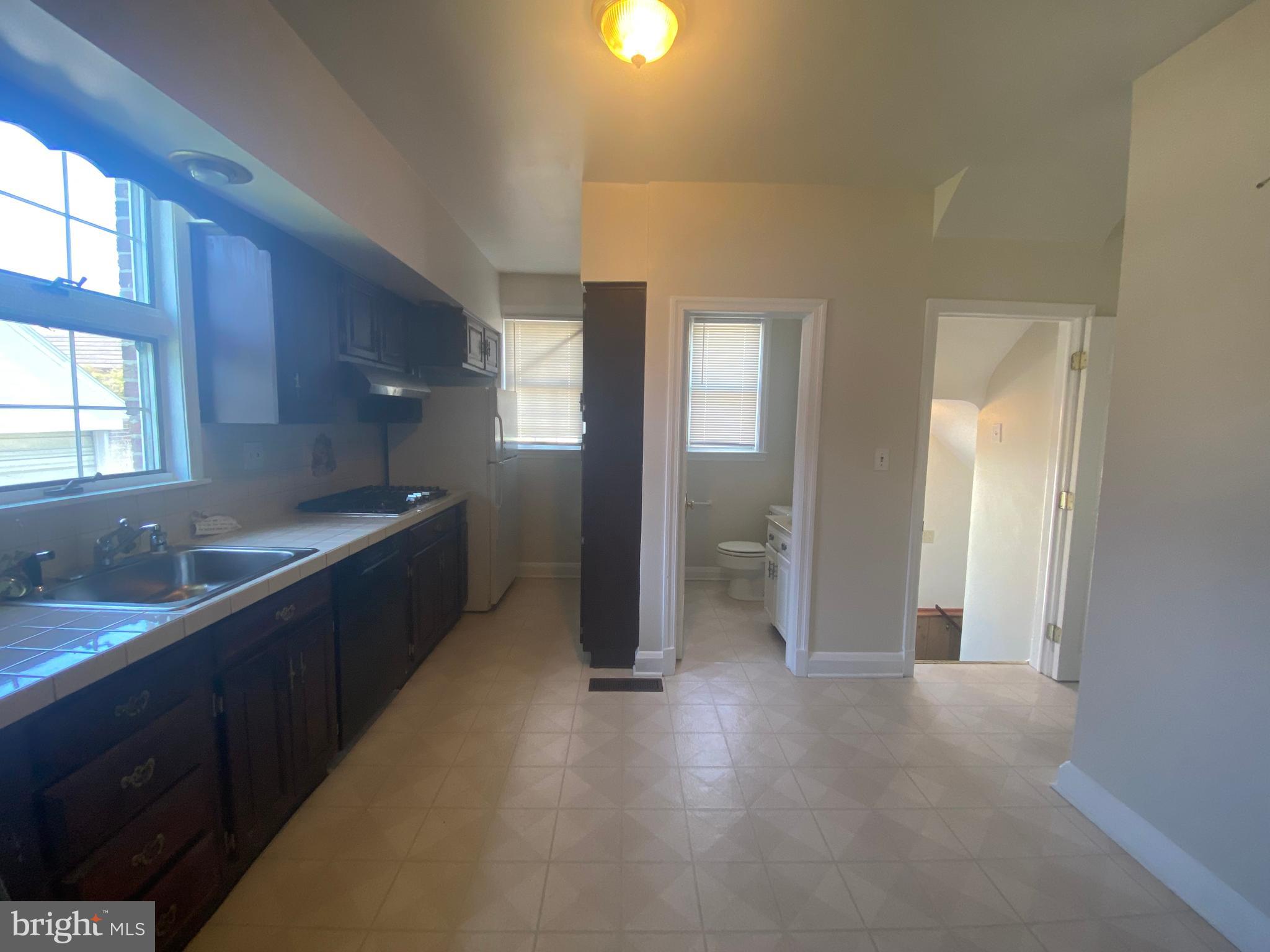 9532 Belair Road Baltimore, MD 21236 - Photo 6 of 20 a kitchen with granite countertop a refrigerator and a sink
