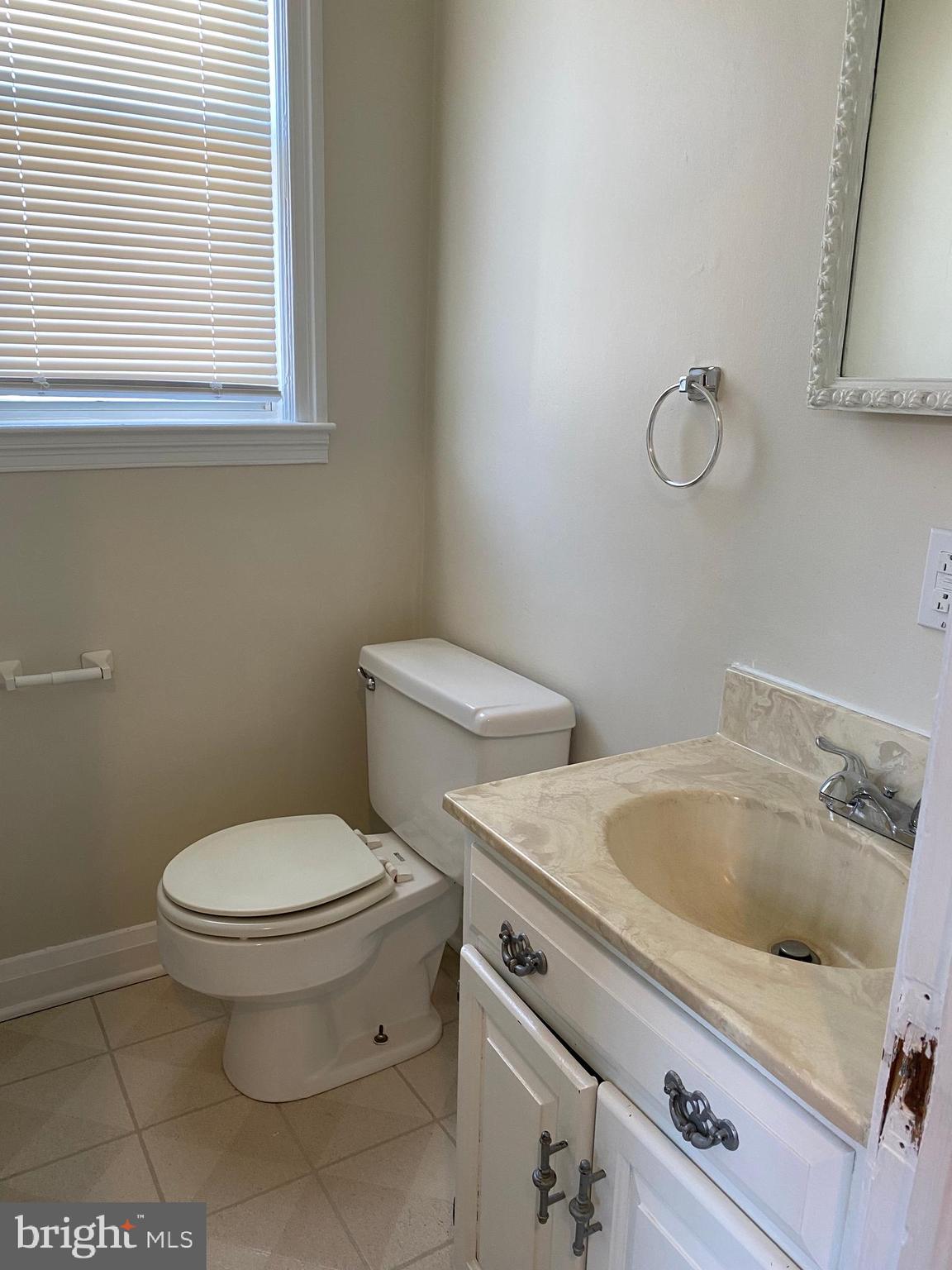 9532 Belair Road Baltimore, MD 21236 - Photo 7 of 20 a white toilet sitting next to a bathroom sink