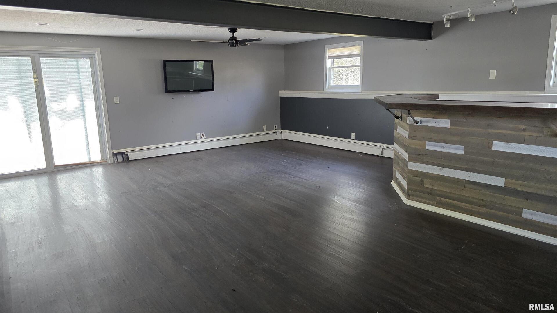 601 Scenic Drive Clinton, IA 52732 - Photo 14 of 16 an empty room with wooden floor and windows