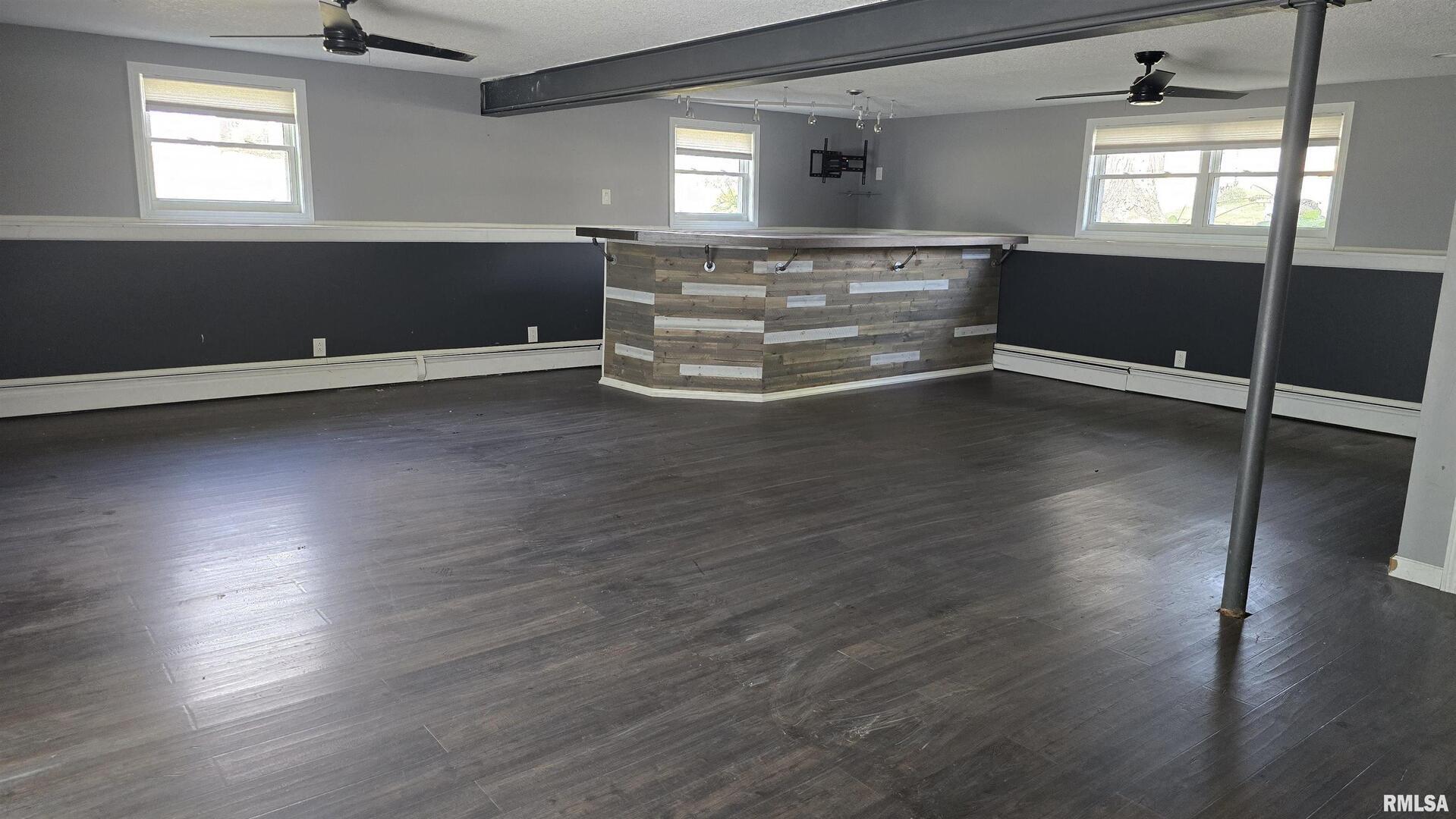 601 Scenic Drive Clinton, IA 52732 - Photo 15 of 16 an empty room with wooden floor and windows