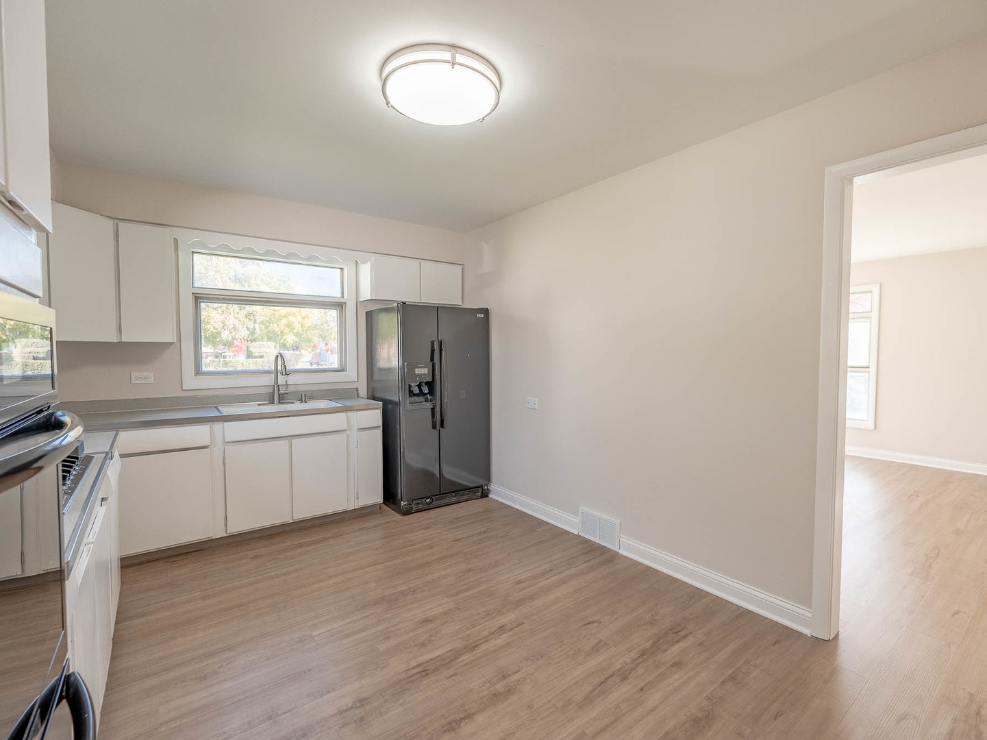 1502 35th Avenue Melrose Park, IL 60160 - Photo 5 of 11 a kitchen with a refrigerator and window