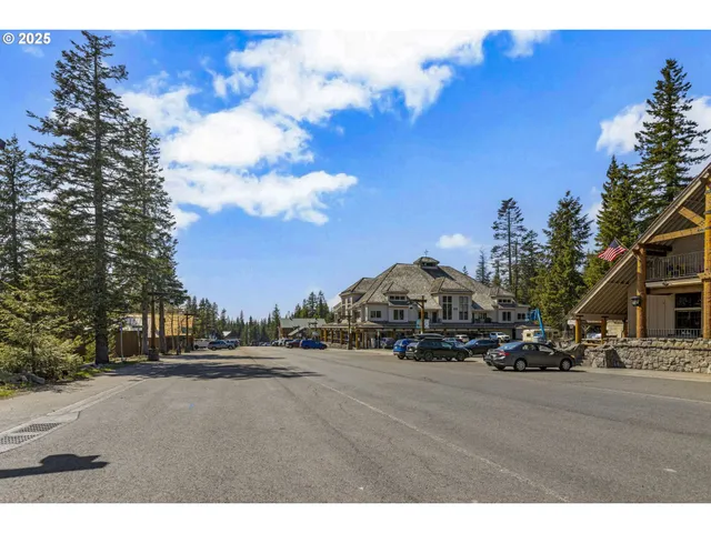 a front view of a building with cars parked