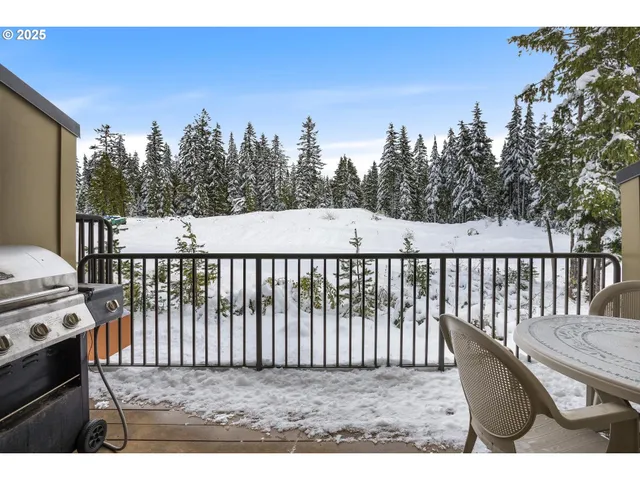 a balcony with table and chairs