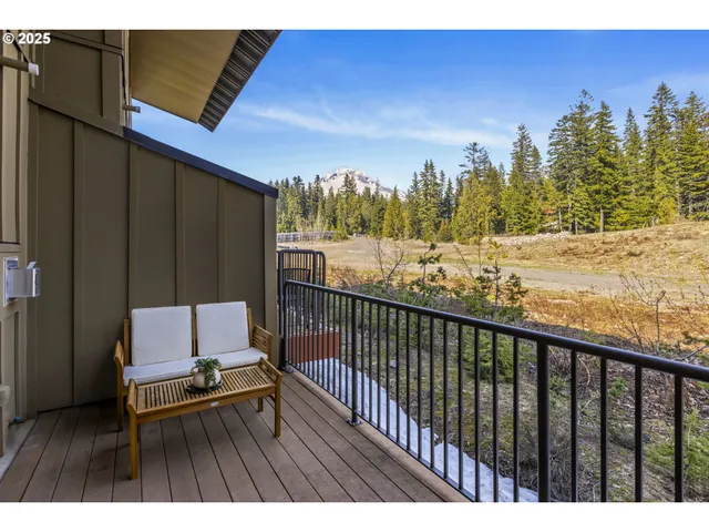 a view of a balcony with chair and wooden floor