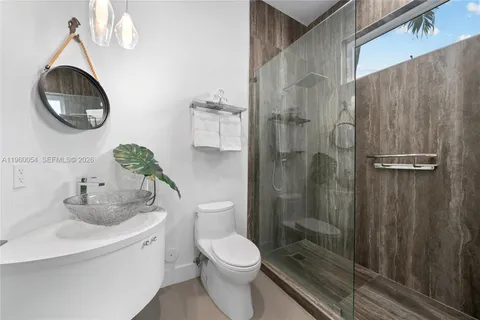 a bathroom with a toilet sink and shower