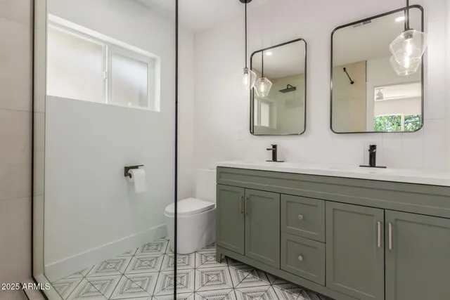 a bathroom with a toilet sink and mirror
