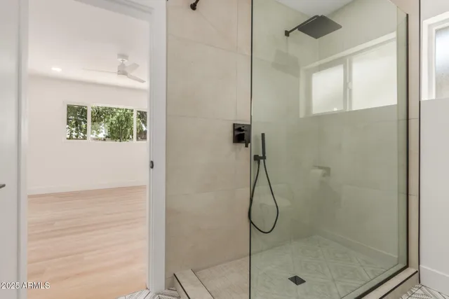 a bathroom with a glass shower door