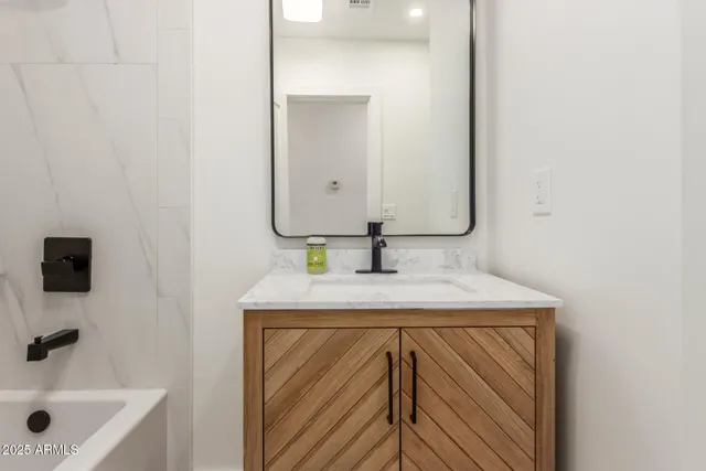 a bathroom with a sink a vanity and a mirror