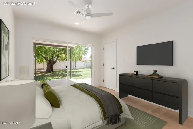 a bedroom with a bed and a flat screen tv