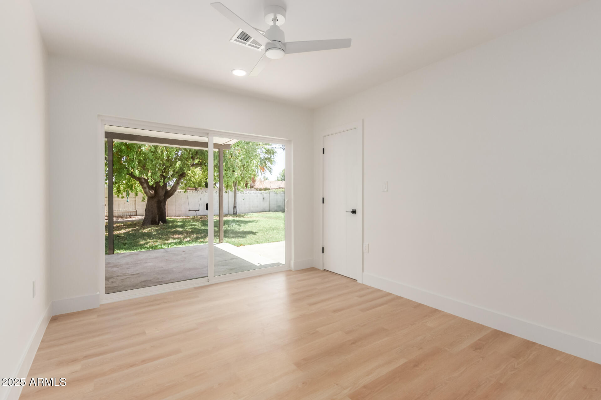 1311 East 2nd Place Mesa, AZ 85203 - Photo 21 of 29 an empty room with wooden floor and windows