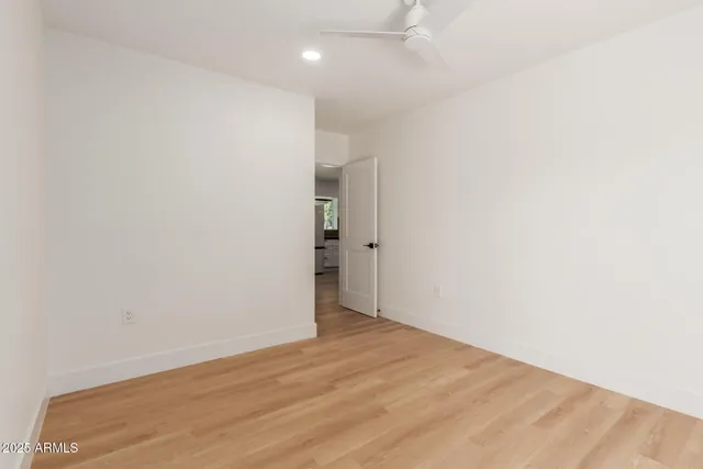 an empty room with wooden floor