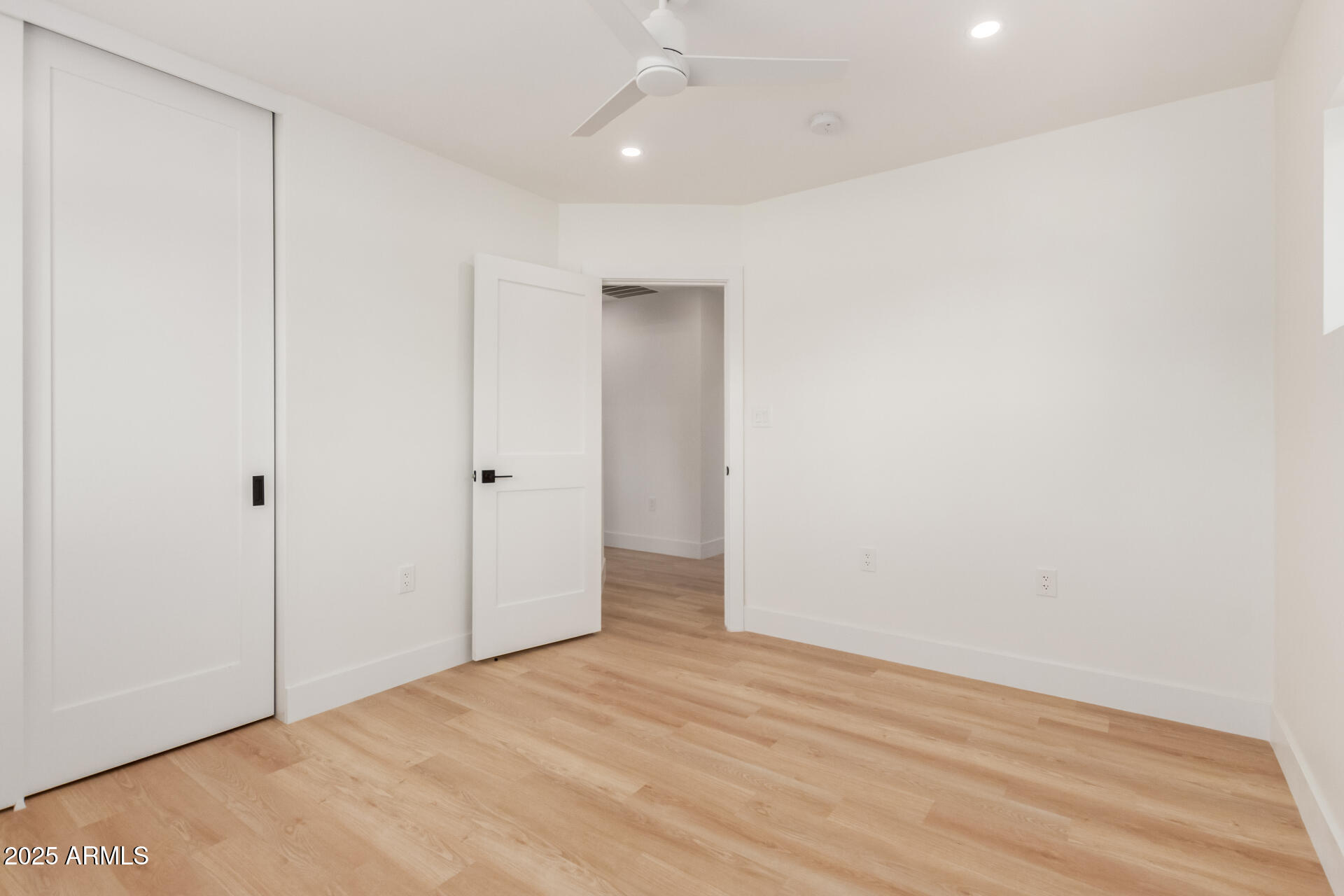 1311 East 2nd Place Mesa, AZ 85203 - Photo 25 of 29 an empty room with wooden floor and windows
