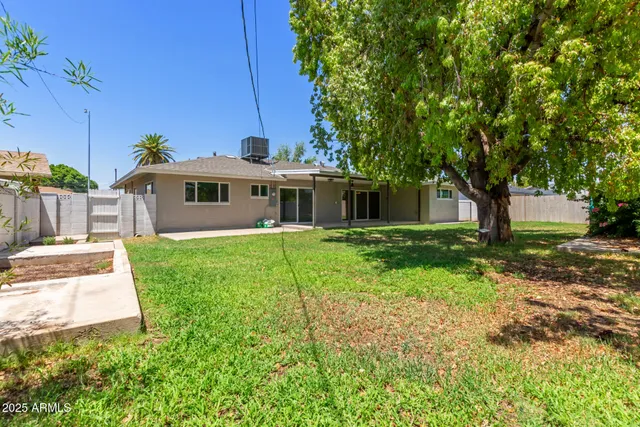 a front view of a house with yard and green space