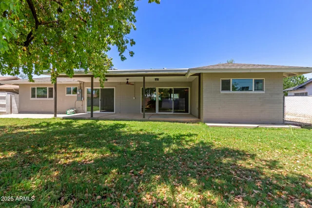 a view of a house with a backyard