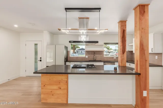 a kitchen with stainless steel appliances granite countertop a stove and a refrigerator