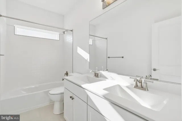 a view of staircase with wooden floor and white walls