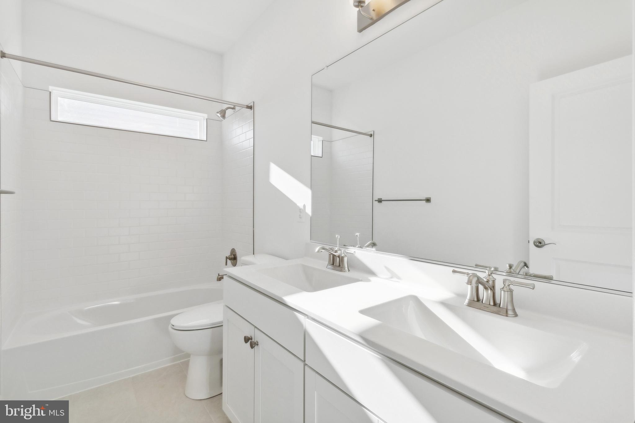128 Patterson Court Middletown, DE 19709 - Photo 26 of 31 a bathroom with a granite countertop sink a toilet and a bathtub