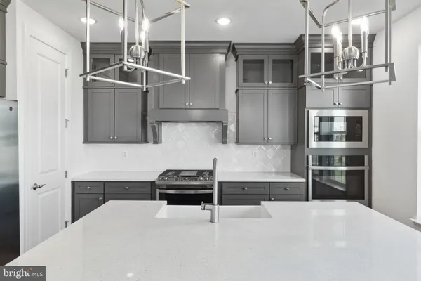 a kitchen with stainless steel appliances a refrigerator and a stove