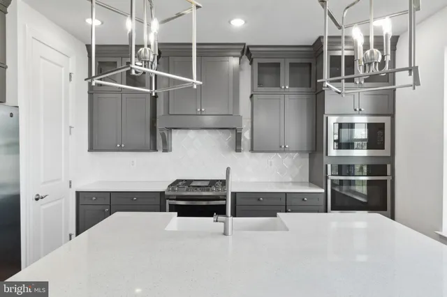 a kitchen with stainless steel appliances a refrigerator and a stove