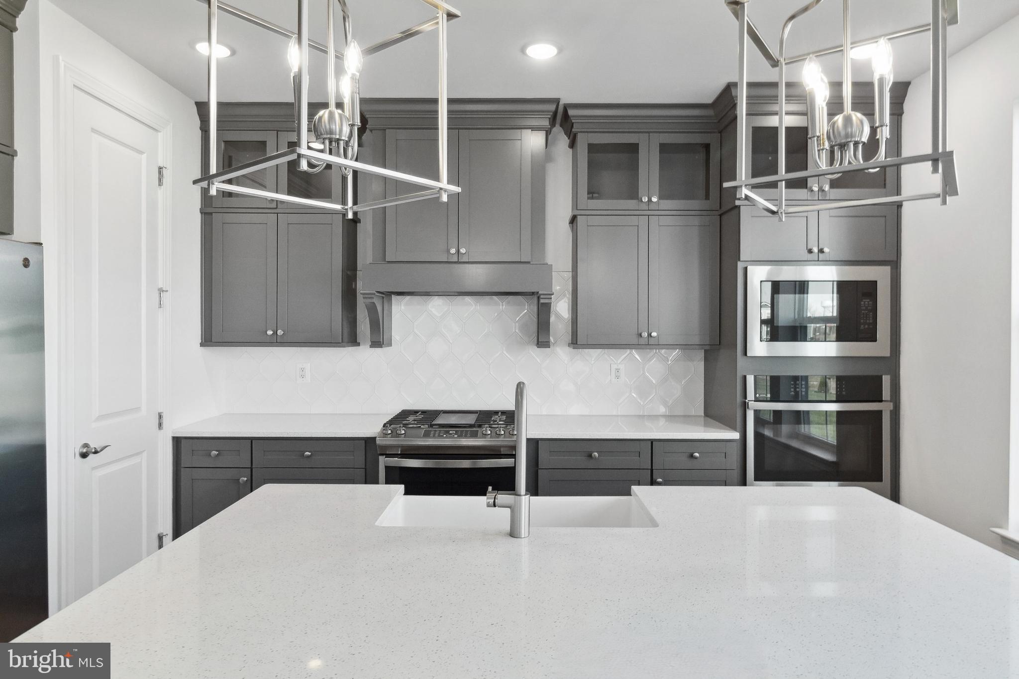 128 Patterson Court Middletown, DE 19709 - Photo 8 of 31 a kitchen with stainless steel appliances a refrigerator and a stove