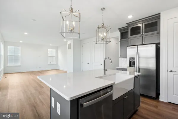 a kitchen with kitchen island a sink stainless steel appliances and kitchen island