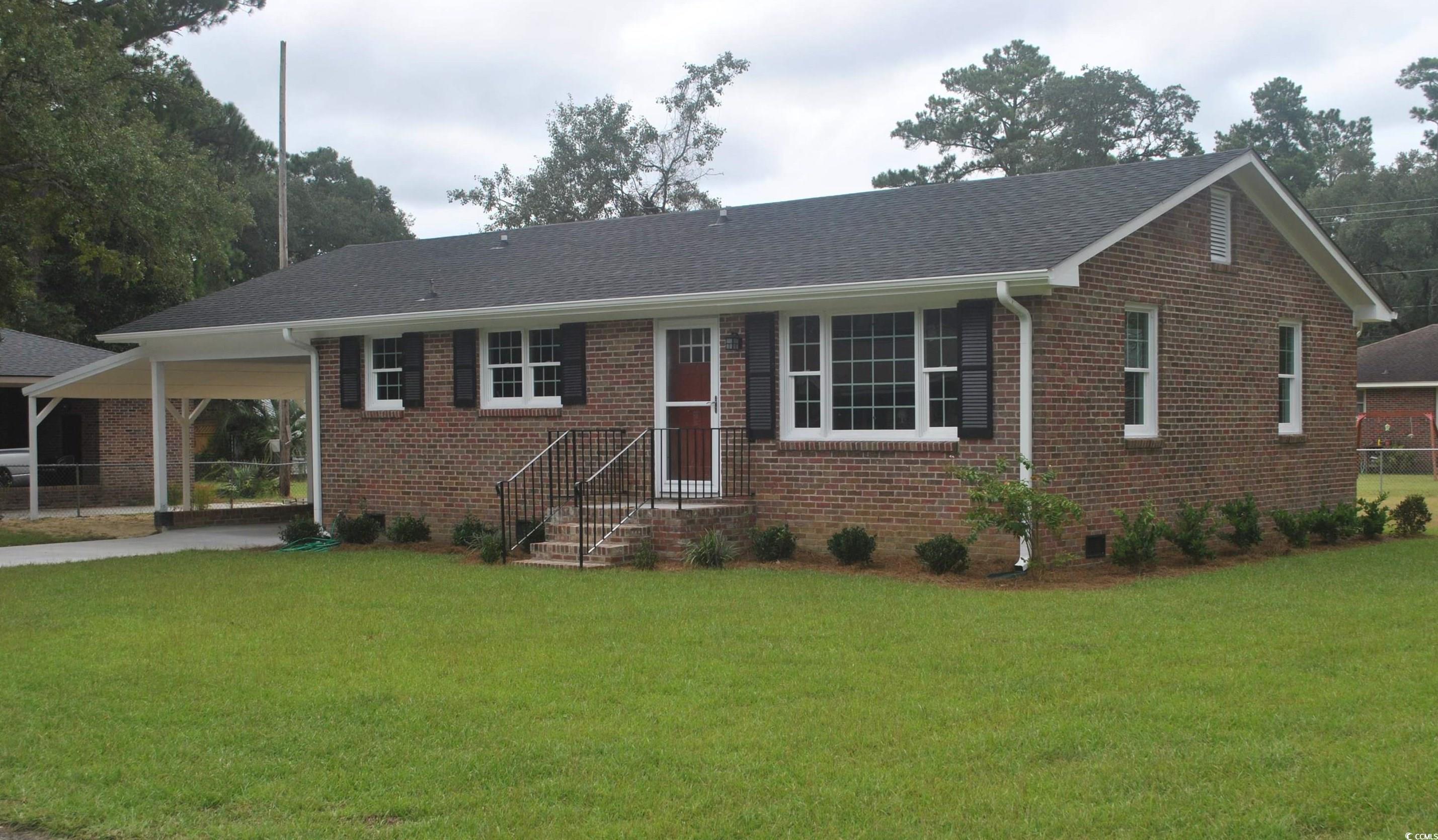 415 Olive Street Georgetown, SC 29440 - Photo 1 of 3 Ranch-style house with a front lawn and a carport