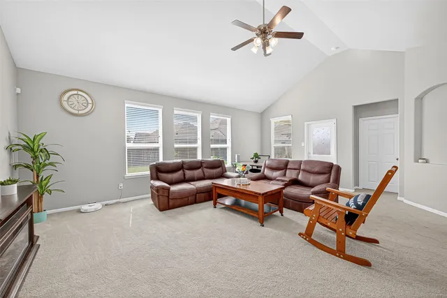 a kitchen with stainless steel appliances granite countertop a stove top oven a sink dishwasher a dining table and chairs with wooden floor