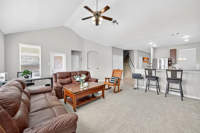 a kitchen with stainless steel appliances granite countertop a refrigerator a sink a stove a microwave and island