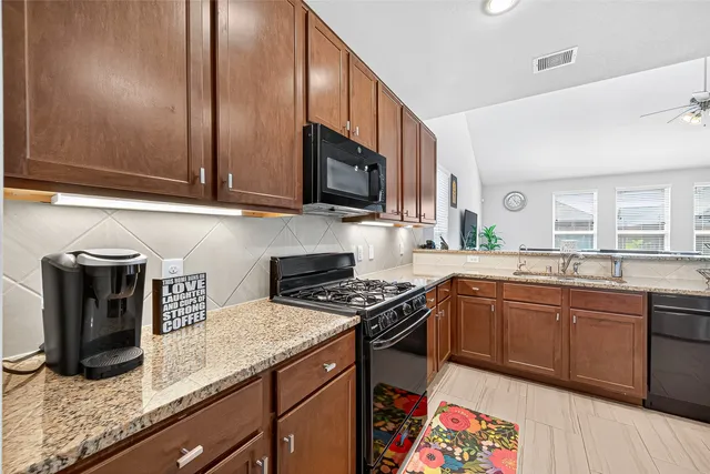 a kitchen with a sink stove and microwave