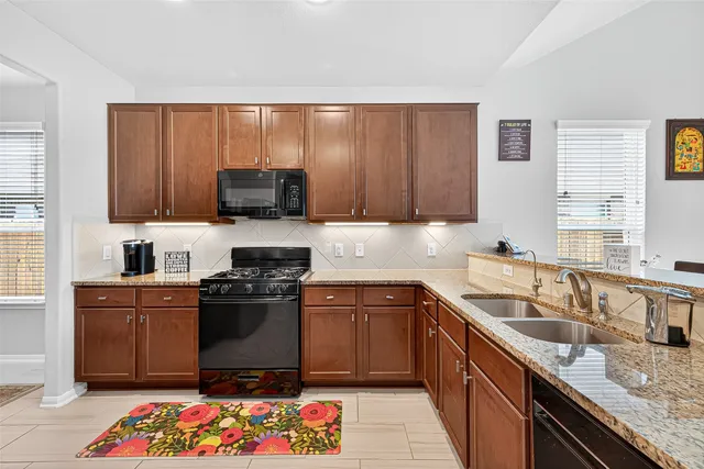 a view of a hallway with wooden floor and electronic appliances