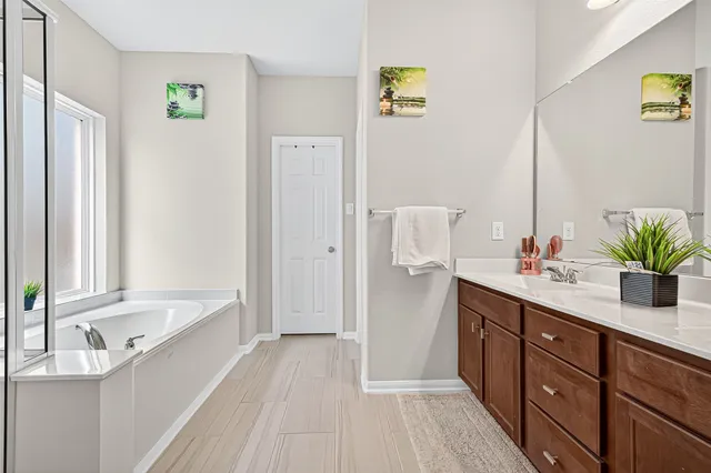 a bathroom with a tub and shower