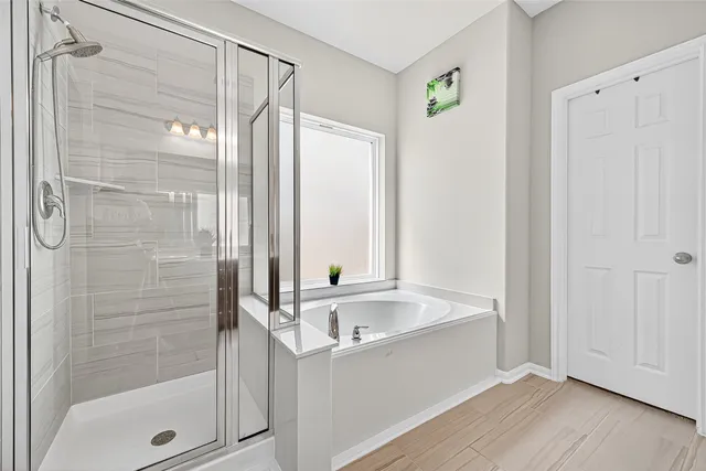 a bedroom with a bed couch and window