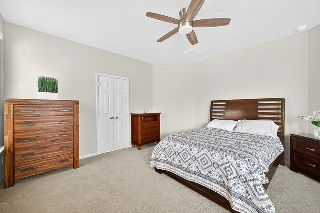 a bedroom with a large bed and a chandelier