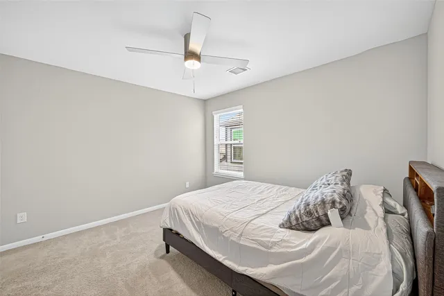 a bedroom with furniture and a window