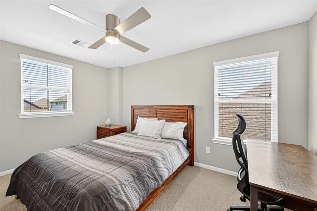 a bedroom with a bed and window